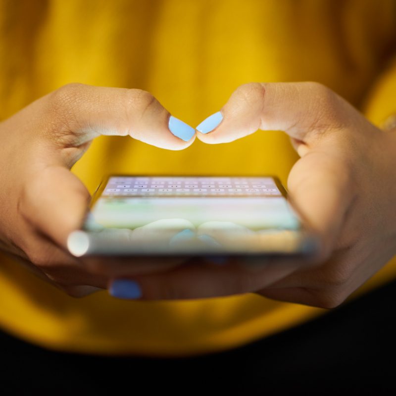 woman-sending-message-using-smartphone