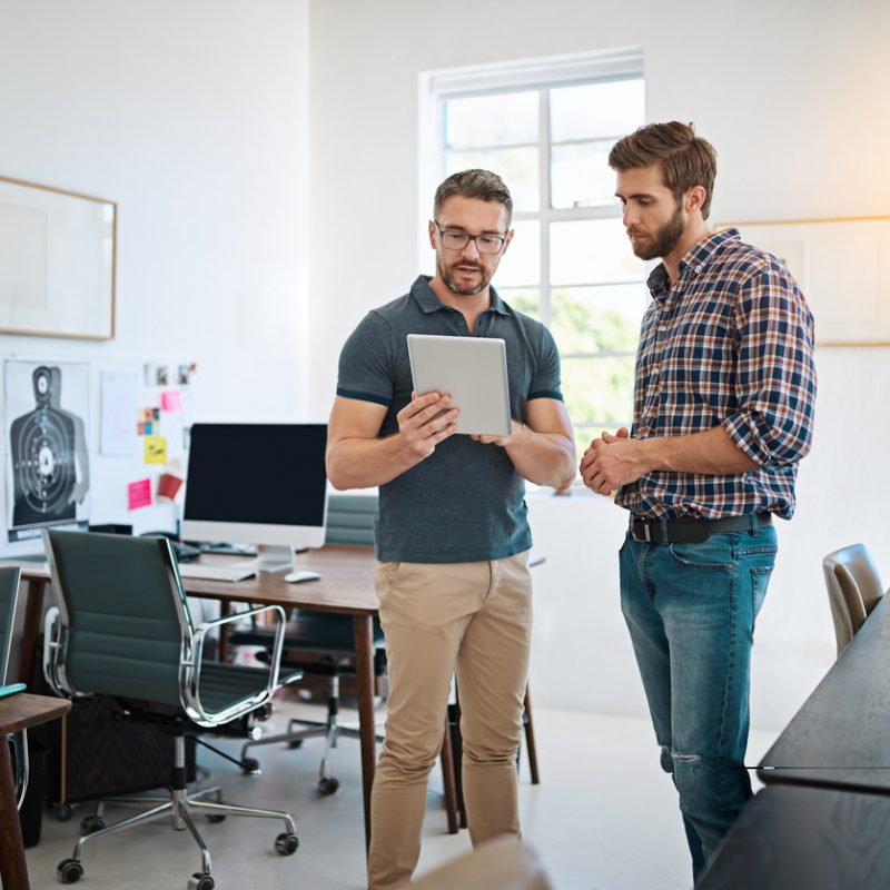 businessmen-looking-at-tablet